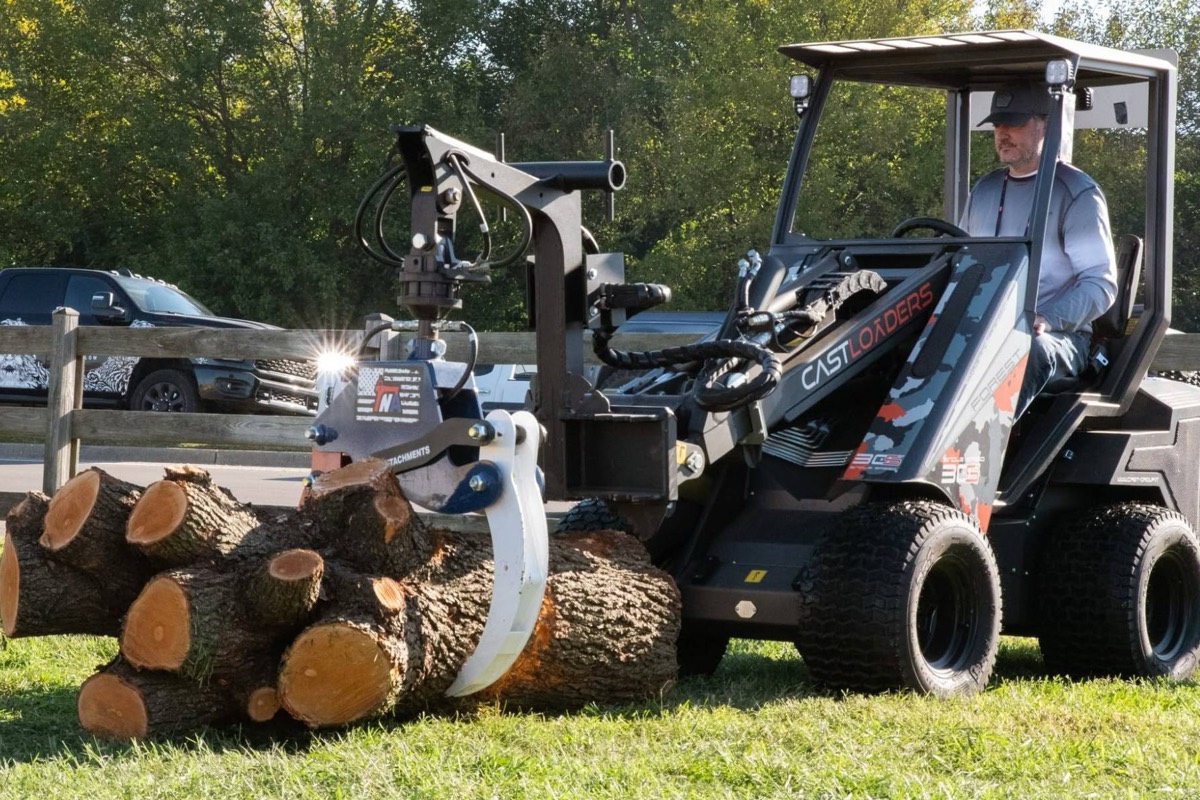 CAST articulating loader moving logs with a grapple